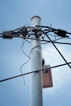 Utility pole with tangled electrical cables and equipment Stock Photos