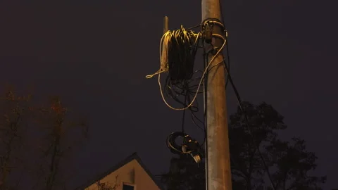 Utility pole with tangled wires and visible splicing suggests ongoing electrical Stock Footage 325127820