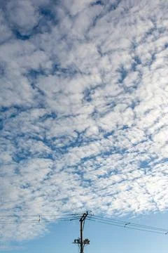 Utility pole under a cloudy sky Stock Photos