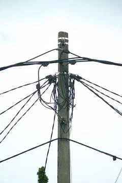 A Utility pole used to support overhead power lines as electrical cables. Stock Photos