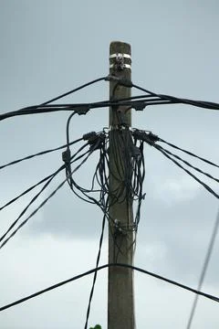 A Utility pole used to support overhead power lines as electrical cables. Stock Photos