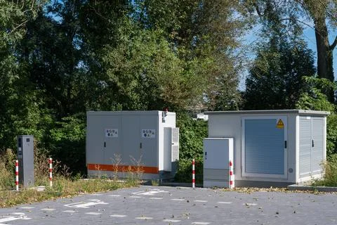 Utility stations located in a green space near a quiet road Stock Photos