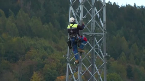 Utility Technician Climbing High Voltage Transmission Tower Stock Footage 341968073