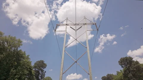 Utility tower for high-voltage power lines cross the countryside as part of the Stockbeeldmateriaal 337182071