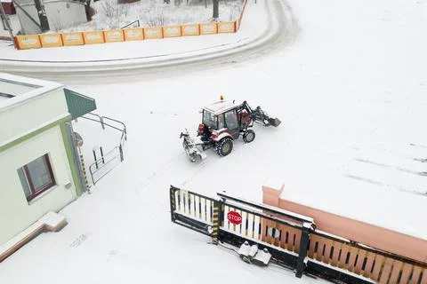 Utility tractor pulled out to clear snow from roads top view. Stock Photos