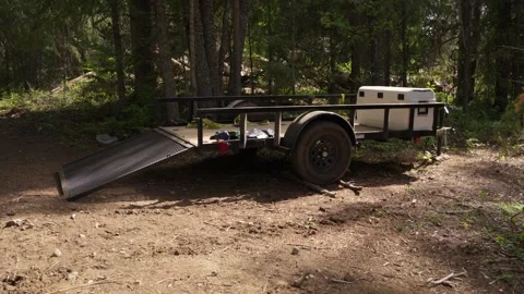 Utility Trailer for ATV Parked in Forest Stock Footage 311204839