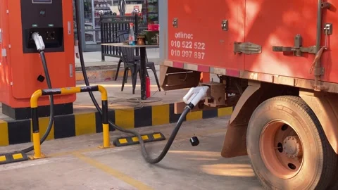 Utility Truck Connected to Electric Charging Station in Outdoor Parking Lot Stock-Footage 334346357