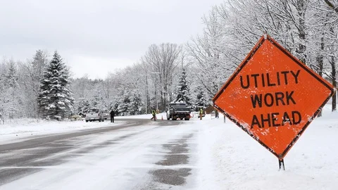 UTILITY WORK AHEAD sign warns traffic about a work crew on road Stock Footage 128620595