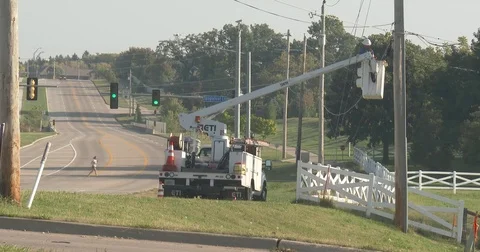 Utility Worker in Bucket Truck - Wide - Stop Light in Background Stock Footage 80271985