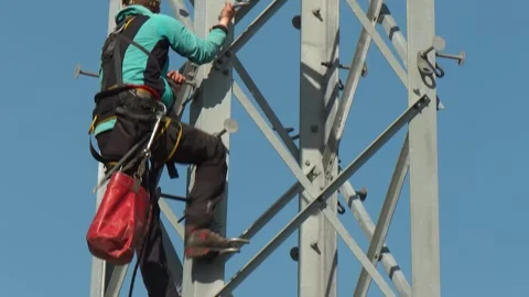 Utility Worker Climbing High Voltage Transmission Tower Stock-Footage 346305174