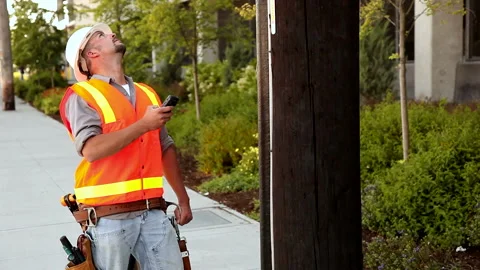 Utility worker messaging on mobile phone Stock Footage 146955358