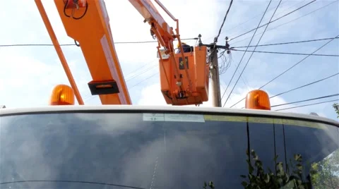 Utility worker performs intervention on electric pole,electricity wire,low angle Video stock 55879648