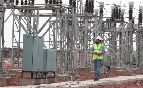 Utility Worker Walking Through Electrical Substation Yard Checking Power Stock Footage 343911442