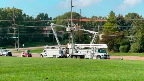 Utility Workers in Bucket Trucks Working on Lines - Wide Shot - Summer Stock Footage 251829382