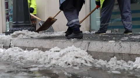 Utility workers clearing snow from the curb Stock Footage 304662971
