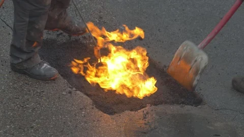 Utility Workers Fixing Gap in a Road by FIlling it with Hot Asphalt Stock Footage 147607978