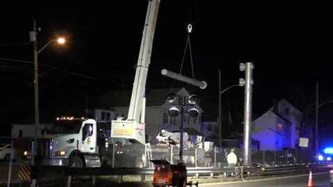 Utility workers install highway sign pole March 15 2023 Revere Massachusetts USA Video stock 259435077