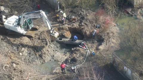 Utility workers repairing main water pipeline leak in pit Stock Footage 336301220