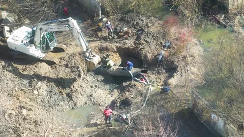 Utility workers repairing main water pipeline leak Stock Footage 342373864