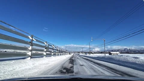 Utility workers repairing power lines on a snowy road in Hokkaido Japan Video stock 332939143
