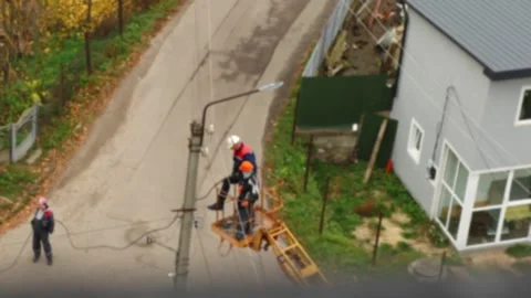 Utility workers repairing power lines on a street in Ukraine, preparing inf.. Stock Footage 342927283