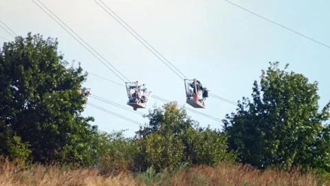 Utility Workers Suspended from Helicopter Installing Overhead Power Line on.. Stock Footage 338163184