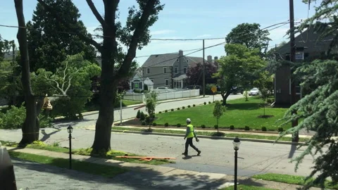 Utility Workers Walking on Empty Suburban Street Stock Footage 131991650