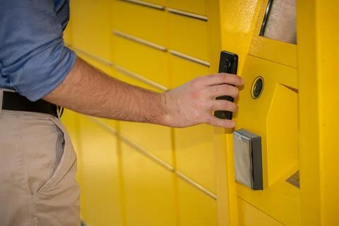 Utilizing a Mobile Device with a Yellow Locking Mechanism for Enhanced Access 写真素材