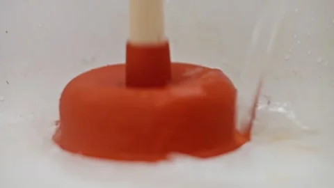Utilizing Plunger Action in Water for Efficiently Unclogging Drains in Your Home Video stock 313383452