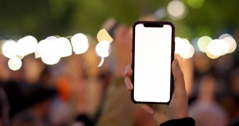 Utilizing a smartphone to beautifully capture unforgettable moments at a lively Stock Footage 318722504