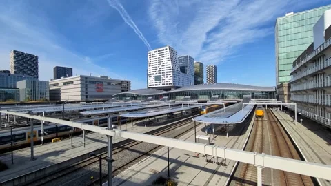 Utrecht Central Station with an approaching train and the Utrecht skyline. Stock Footage 326165604