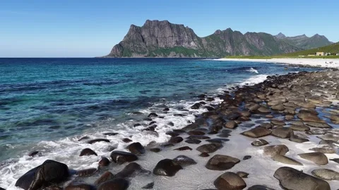 Uttakleiv beach waves gently rolling on rocky shore in lofoten, norway Stock Footage 317103983