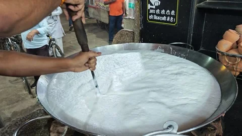 UTTAR P, INDIA- OCTOBER 10, 2025: Street vendor boiling milk in a large pot Stock Footage 327151199