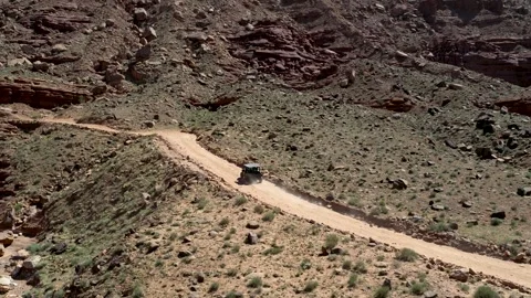 UTV driving along Chicken Corners trail in Moab desert canyon landscape zoom Stock Footage 333715853