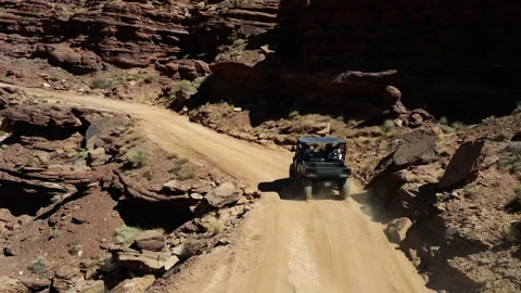 UTV driving along Chicken Corners trail in Moab desert canyon landscape Stock Footage 334010100