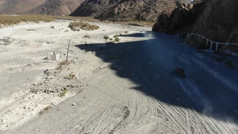 UTV driving through desert by mountains Stock Footage 166662031
