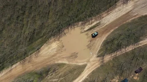 UTV driving through a large puddle, top view Stock Footage 159474241