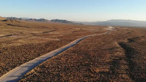 UTV racing down a long dirt road Stock Footage 166662423