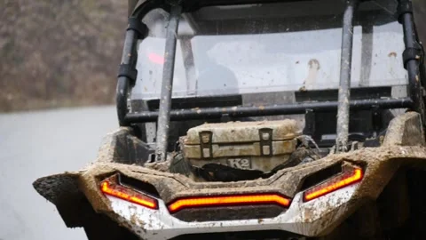 UTVs, side by side ATVs riding down a mountain road in a line, slow motion Stock Footage 270278013