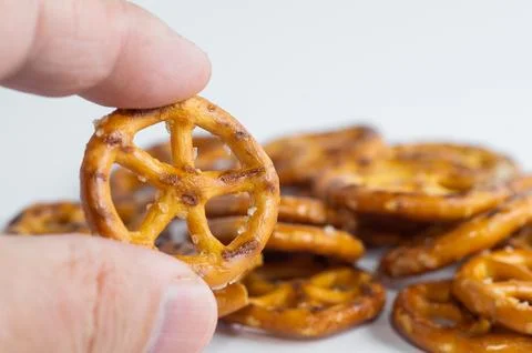 UTZ Classic Pretzel Wheels held in hand. Close-up. Stock Photos