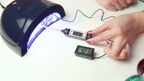 UV lamp nail thermometer test Stock Footage 197359614