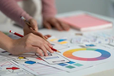 UX and UI Design Process. Designers sketching user interface ideas on paper. Stock Photos