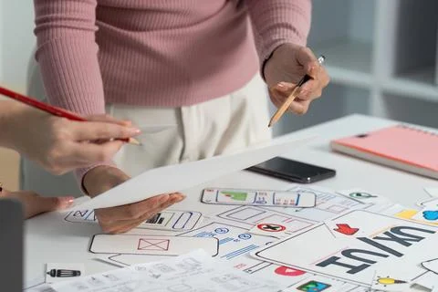 UX and UI Design Process. Close-up of hands reviewing sketches in a Stock Photos