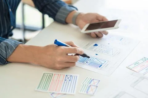 Ux designer creative planning application development near layouts of mobile Stock Photos