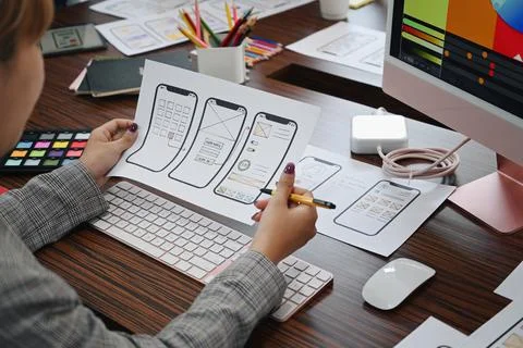 UX designer planning application template layout framework for mobile phone at Stock Photos