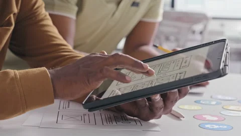 UX Designer Showing Mobile App Interface Sketch on Tablet Vídeo Stock 232417320