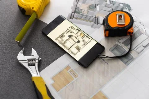 UX designer working on the mobile application experience sketching drawings at Stock Photos