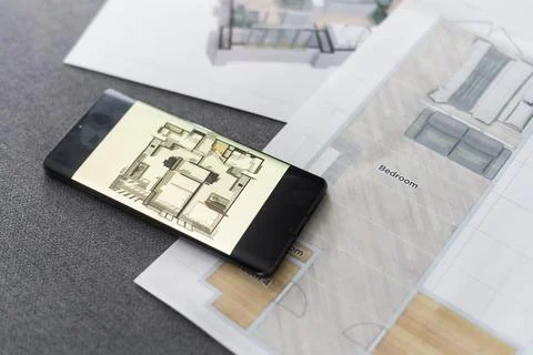 UX designer working on the mobile application experience sketching drawings at Stock Photos