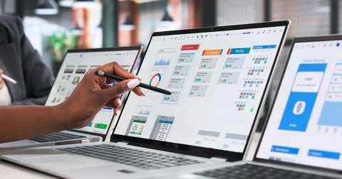 UX Designers Discuss App Interface Ideas While Working Together On Laptop. Stock Photos