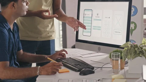 UX Designers Discussing Mobile App Wireframe on Computer Stock Footage 232414247